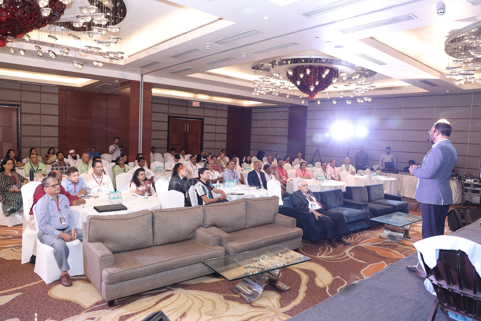 Dr. Selukar speaking to a live training audience during an integrative wellness session