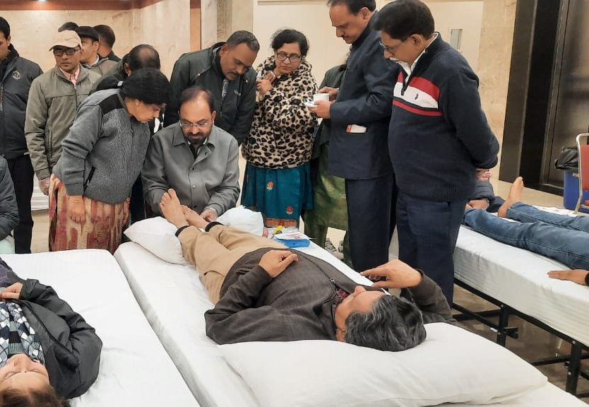 Hands-on reflexology demonstration at a community health awareness camp