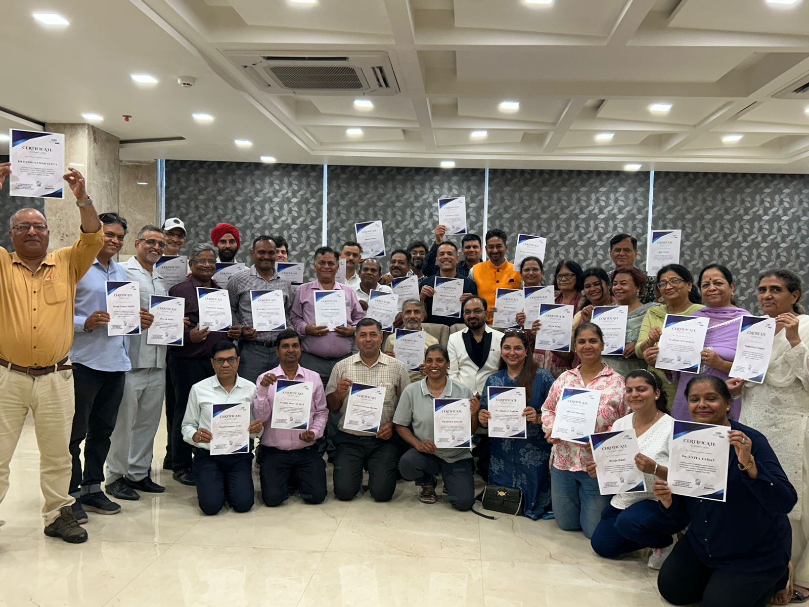 Graduating cohort proudly displaying their reflexology certificates